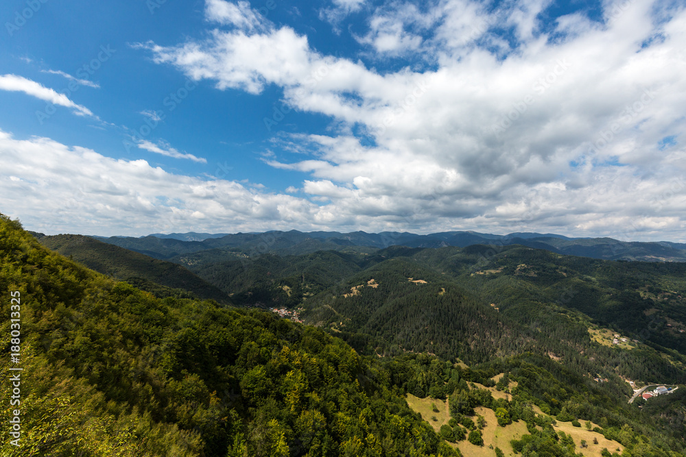 Naklejka premium Mountain and forest with dramatic cloudy sky
