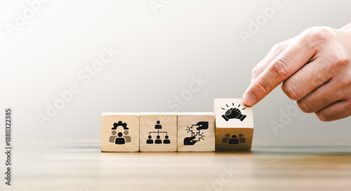 Foto Wooden blocks displaying icons of teamwork, organizational structure, problem so