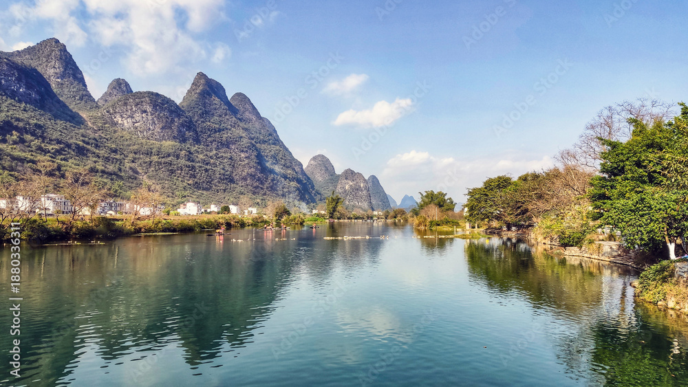 Fototapeta premium Lush Green Mountains under Blue Sky Scenic View