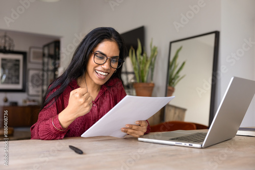 Konstfotografi Happy excited young adult Indian girl in stylish glasses getting formal letter w