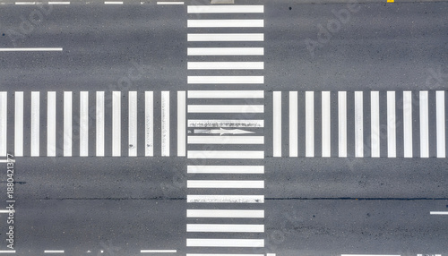 Top view of pedestrian crosswalk white lines on asphalt road