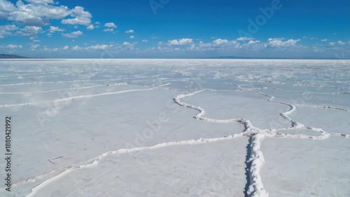 Salt flat white surface with hexagon pattern salt crust landscape blue sky and scattered clouds