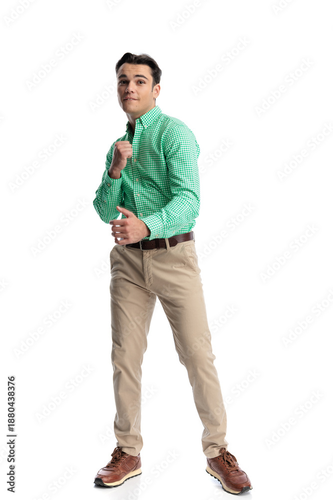 Fototapeta premium Anxious casual man biting lip and holding fists up
