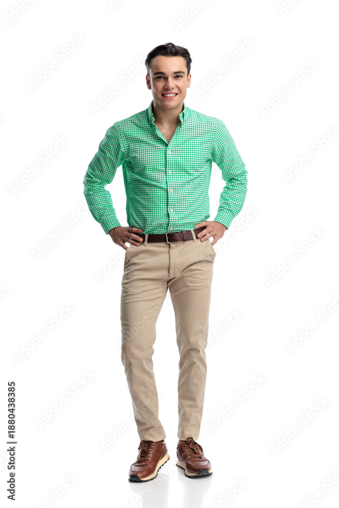 Fototapeta premium Happy young casual man standing with hands on hips