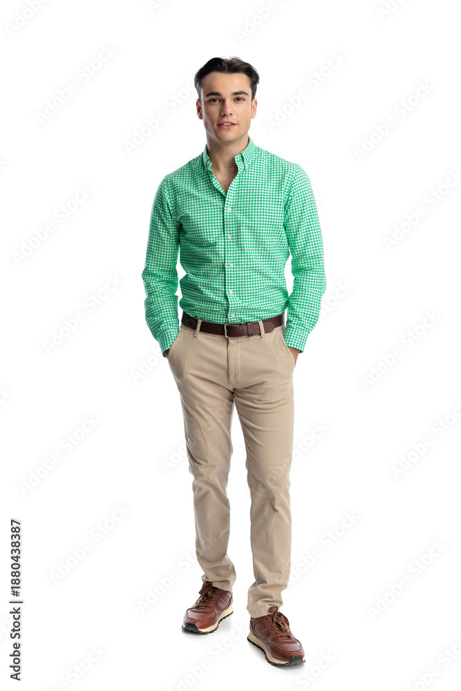 Fototapeta premium Confident young man standing with hands in pockets