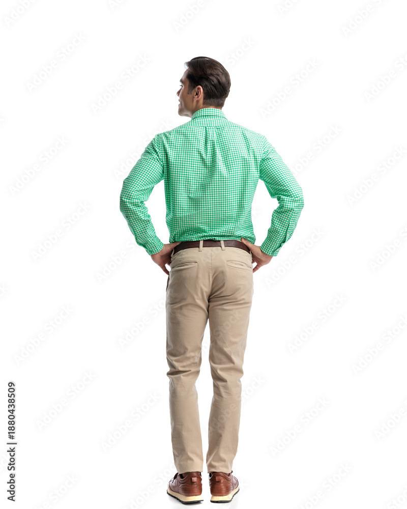 Fototapeta premium Casual young man waiting while looking to the side