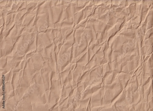 Crumpled brown paper with texture on display in bright light for crafting and design use