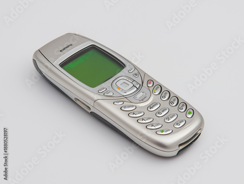 Wallpaper Mural Silver mobile phone lies flat on a clean white background, showcasing its simple yet elegant design Generative AI Torontodigital.ca