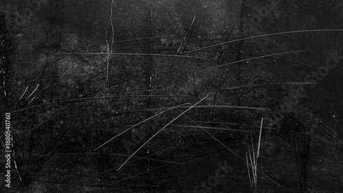 Grunge black background with scratch marks, dust, and noise. Dark abstract dirty texture with distressed overlay. White dust particles and scratches on black grunge surface.