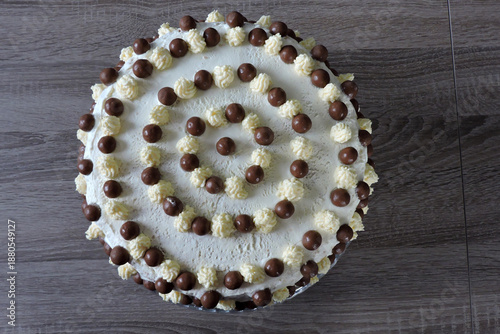 Wallpaper Mural A minimalist homemade white birthday cake with chocolate balls and buttercream peaks, top view Torontodigital.ca