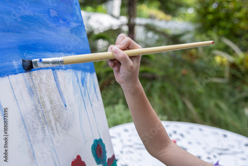 Bild auf Leinwand Happy family, mother, grandmother and daughter are having fun painting with wate