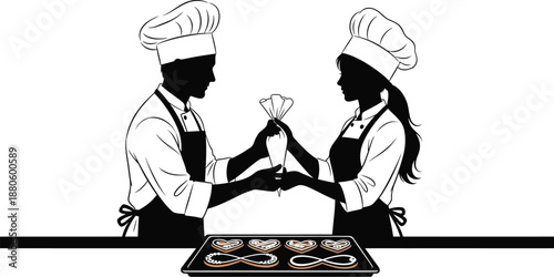 Two silhouetted pastry chefs collaborating skillfully to decorate heart shaped cookies with icing using a piping bag.