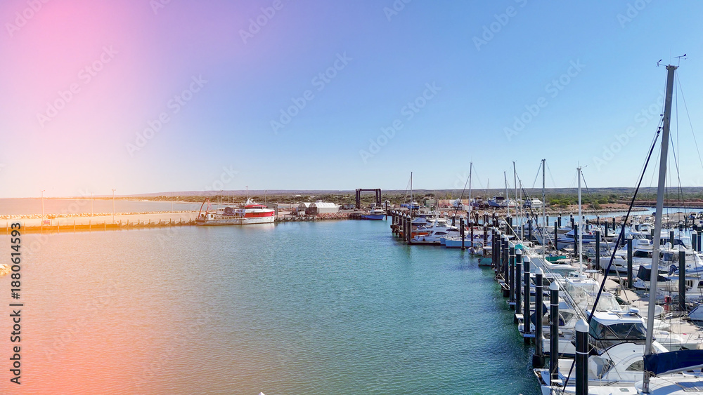 Obraz premium Drone shot of Exmouth harbor Western Australia capturing marina, coastline, and surrounding outback