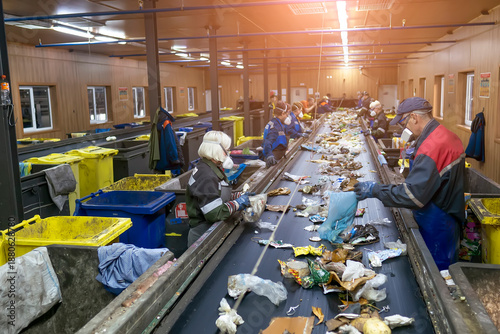 Photos Conveyor for sorting garbage waste by people. Garbage processing?