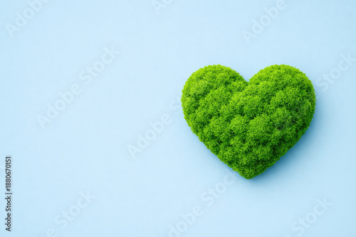 Earth Day Green moss heart shape on blue background for environmental awareness campaign