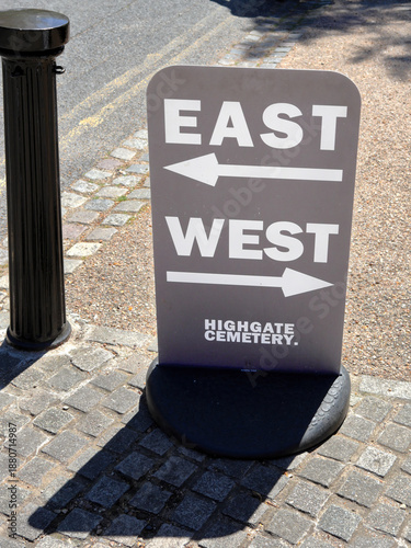 Sign indicating East and West parts of the Highgate Cemetery in North London, UK
