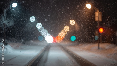 Snow Falls on a Quiet Street at Night With Lights Shining Through the Snowfall