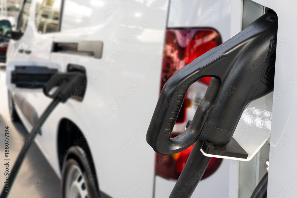 Fototapeta premium Electric delivery van with electric vehicles charging station