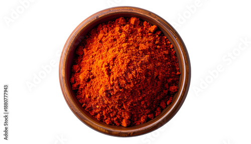 Overhead shot of a rustic wooden bowl filled with vibrant red-orange spice powder