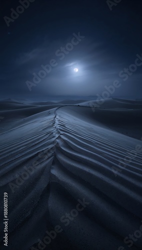 Ethereal moonlight illuminates the vast, sculpted sand dunes of an enigmatic desert landscape, casting long, dramatic shadows under a serene night sky