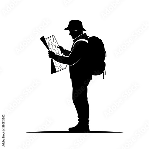 Backpacker examining map while standing outdoors.