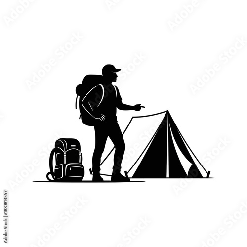 Backpacker standing beside tent outdoors.