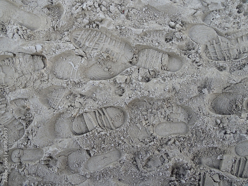 Several footprints on a beach