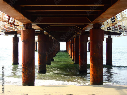 Rustic Pier Symmetry Over Calm Ocean Waters