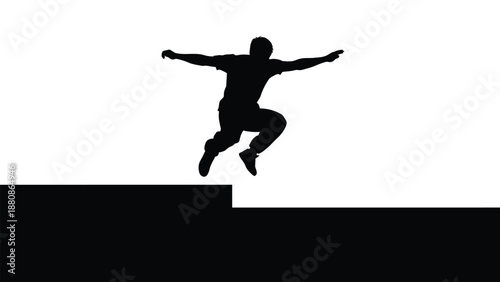 Black silhouette of man jumping off ledge with arms outstretched
