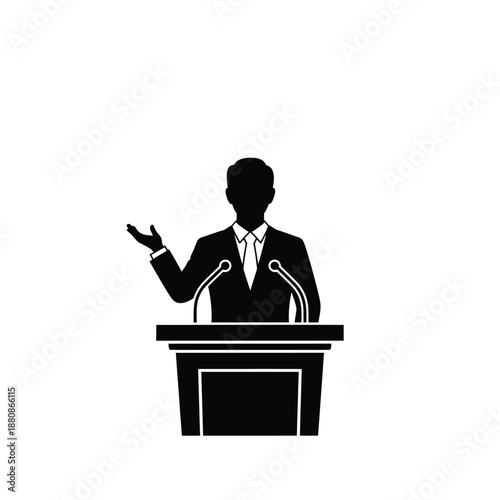 Man in suit speaking at podium with two microphones