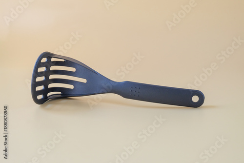 Foto Black potato masher on background