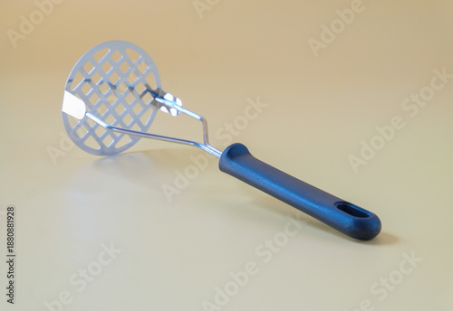 Foto Black potato masher on background