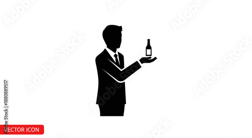 Man in suit holding wine bottle.