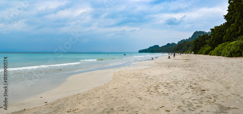 Serene Island Coastline: Turquoise Water and Summer Clouds over a Sandy Beach
