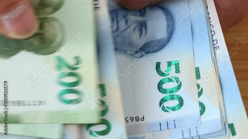 Mexico money. Counting a larger amount of cash. Mexican pesos, businessman's hands. Close up. Financial concept