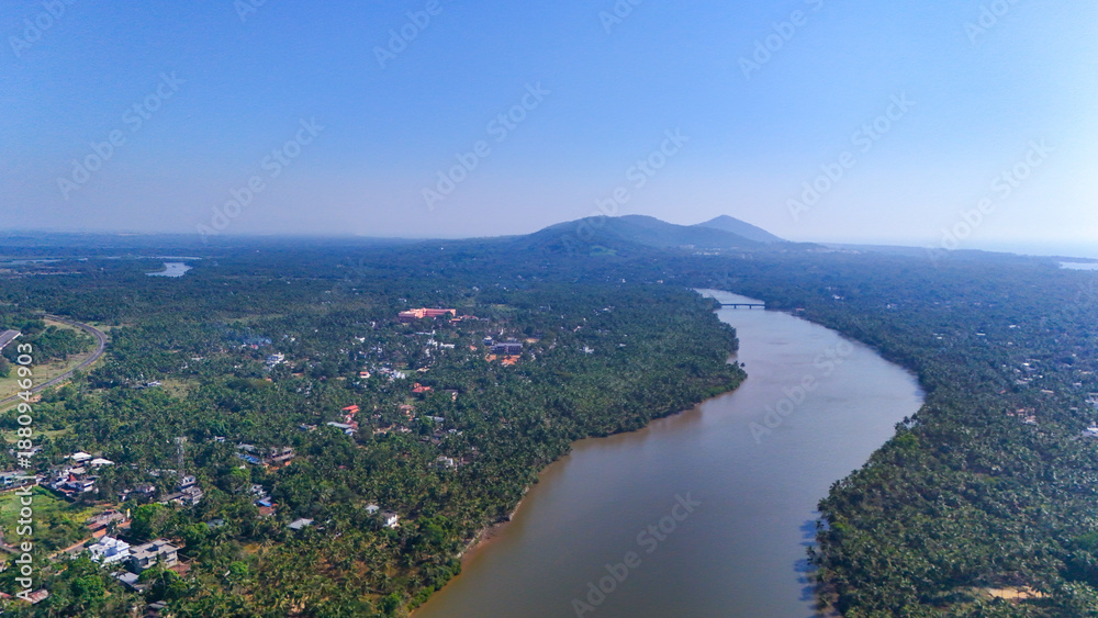custom made wallpaper toronto digitalScenic landscape view of Ezhimala hills situated in Kannur district, Kerala. The image captures the majestic seven hills overlooking the Arabian Sea, surrounded by lush greenery and rocky terrain.