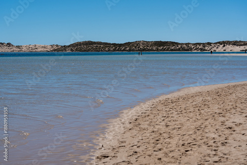 Wallpaper Mural Serene winter scene at Coral Bay beach featuring shallow azure ocean fine sand seashells and distant reef horizon WA coastal retreat Torontodigital.ca