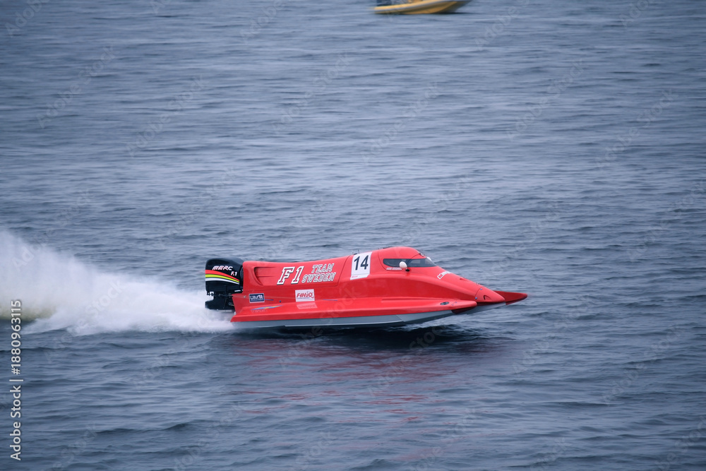 Fototapeta premium Vyshgorod, Ukraine - July 22, 2012. F1H2O powerboat gliding over waves and leaving a white spray trail during an exciting championship race