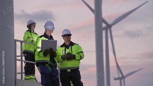 Engineers working on site in wind turbine farm at sunset, Wind turbines generate clean energy source, Eco technology for electric, industry environment, sustainable technology wind power maintenance.