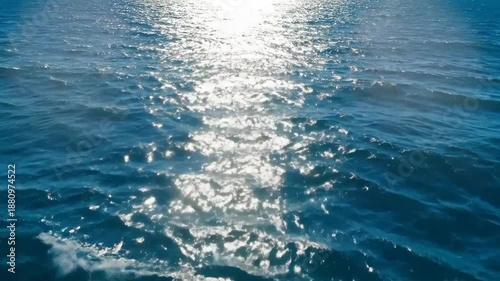 Sunlight reflecting on the surface of the ocean, creating a shimmering and sparkling effect.