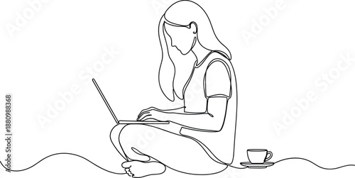 a young woman sitting on the floor and working on a laptop with coffee.