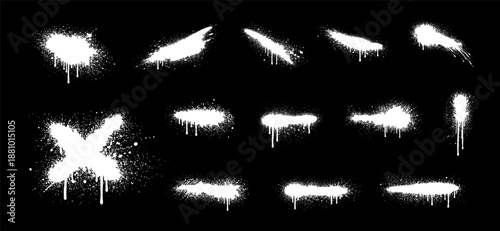 Set of white graffiti spray paint splashes, drips, and textures isolated on black background. Urban street art design elements.