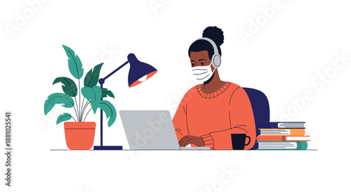 Focused woman wearing a face mask and headphones working on a laptop at a desk with books, a lamp, and a plant.