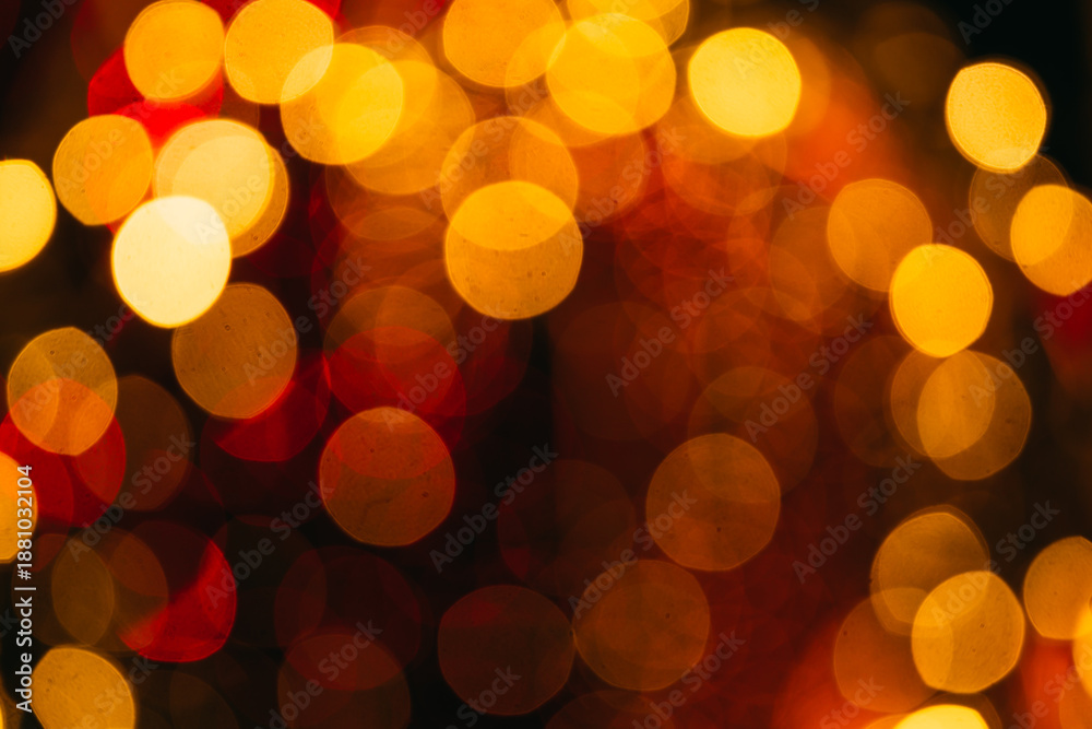 Fototapeta premium Abstract defocused light background with yellow and orange bokeh circles, conveying warmth, celebration, and a cozy luminous atmosphere.