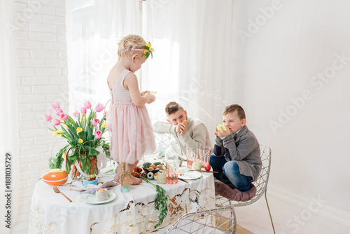 Kids playing on Dyngus Day at breakfast table - Easter Monday in Poland