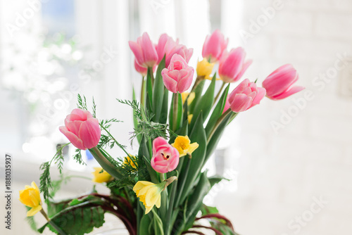 Bouquet of fresh tulips and carrots as unique Easter table decor