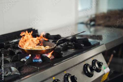 Intense restaurant kitchen activity with vibrant lighting effects
