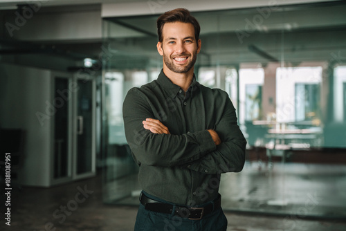 Quadro su tela Handsome latin hispanic young CEO business man with crossed arms smiling at camera