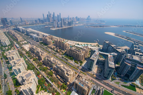 Palm Jumeirah trunk aerial view with Dubai Harbour and Marina at the back. Palm Jumeirah is an archipelago of artificial islands on the Persian Gulf, from top of The View Palm Jumeirah, Dubai, UAE