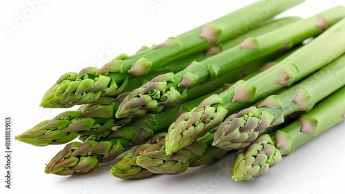 Fresh green asparagus spears arranged on a white surface, ready for cooking.